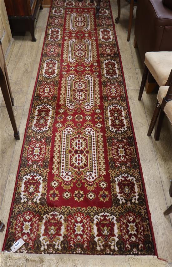 A Persian red ground runner 340 x 80cm